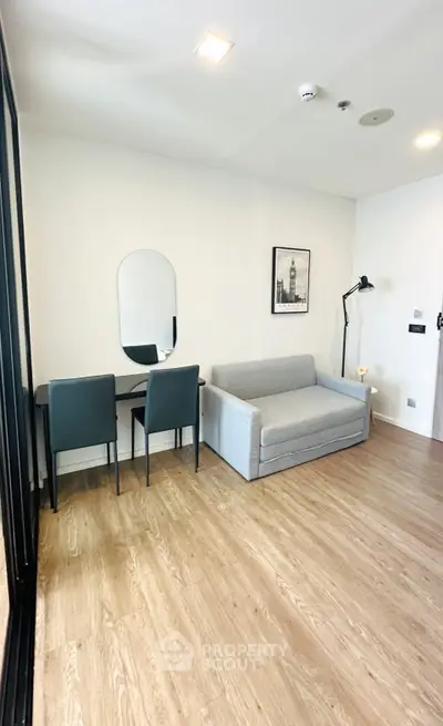 Modern living room with stylish furniture and wooden flooring, perfect for cozy urban living.