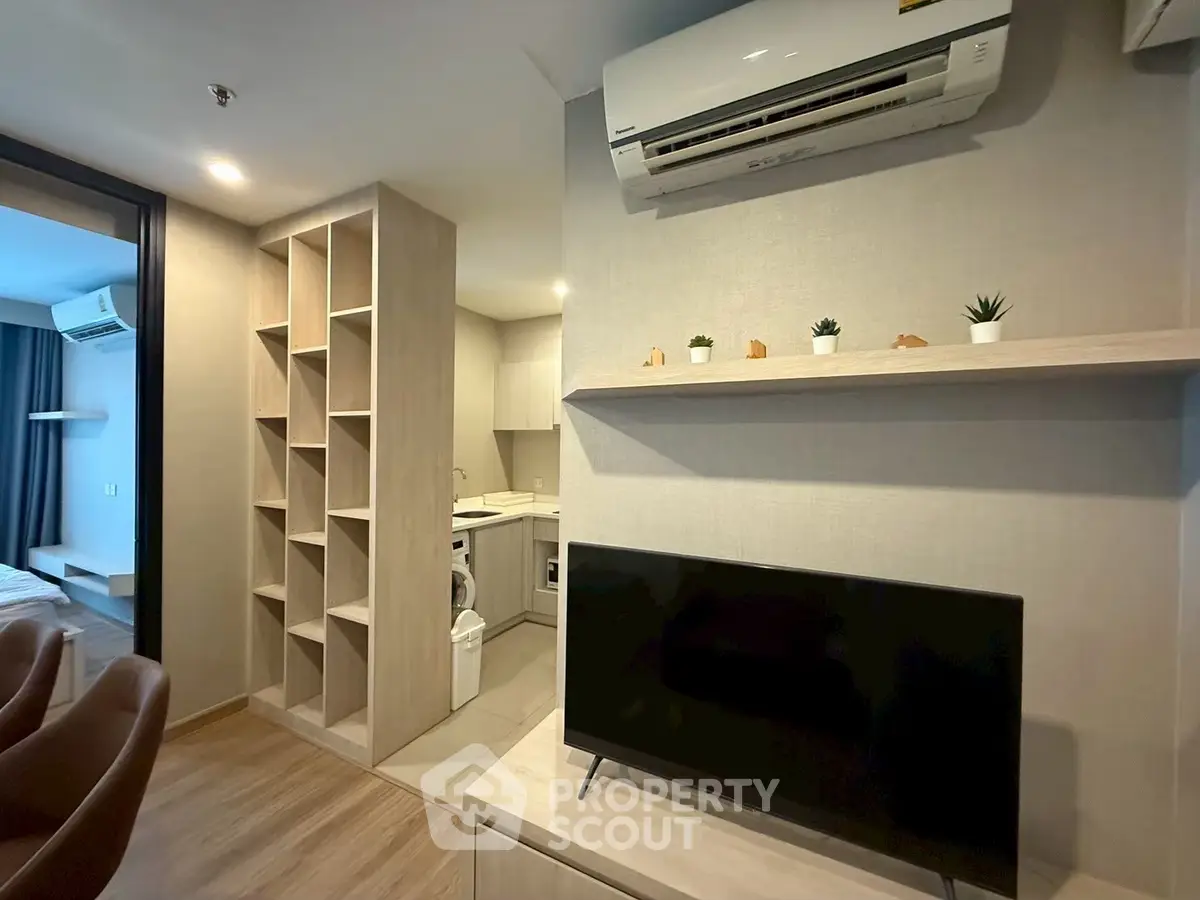 Modern apartment interior with open layout, featuring a cozy living area and stylish kitchen.