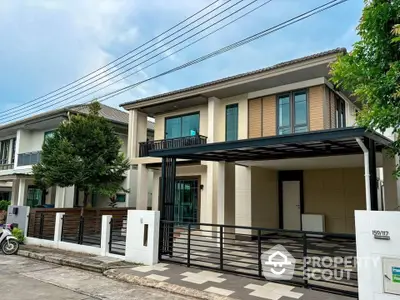 Modern two-story house with spacious driveway and stylish facade in suburban neighborhood.