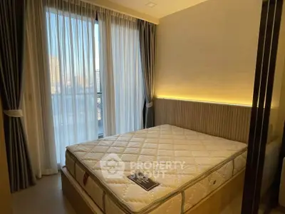 Modern bedroom with large window and stylish lighting in urban apartment