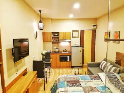Modern studio apartment with cozy living area and compact kitchen