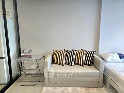 Modern living space with cozy sofa and stylish decor in a compact apartment.