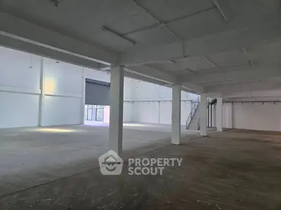 Spacious industrial warehouse with high ceilings and ample natural light