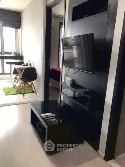 Modern apartment interior with sleek TV setup and dining area