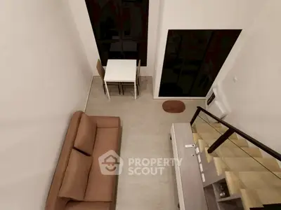 Modern loft-style living room with high ceiling and minimalist decor