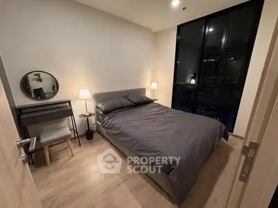 Cozy modern bedroom with stylish decor and large window view