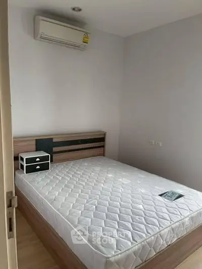 Cozy bedroom with modern air conditioning and minimalist decor, perfect for restful nights.