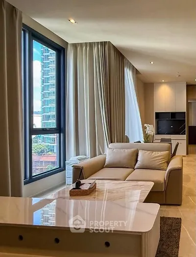 Luxurious modern living room with large windows and elegant furnishings