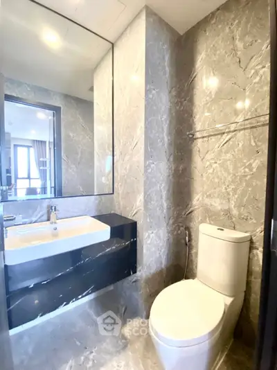 Luxurious modern bathroom with marble walls and sleek fixtures in a high-end property.