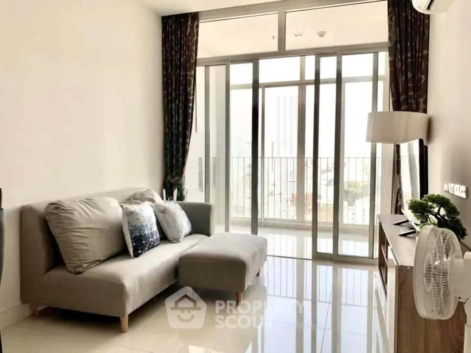 Modern living room with large windows and city view, featuring a cozy sofa and sleek decor.