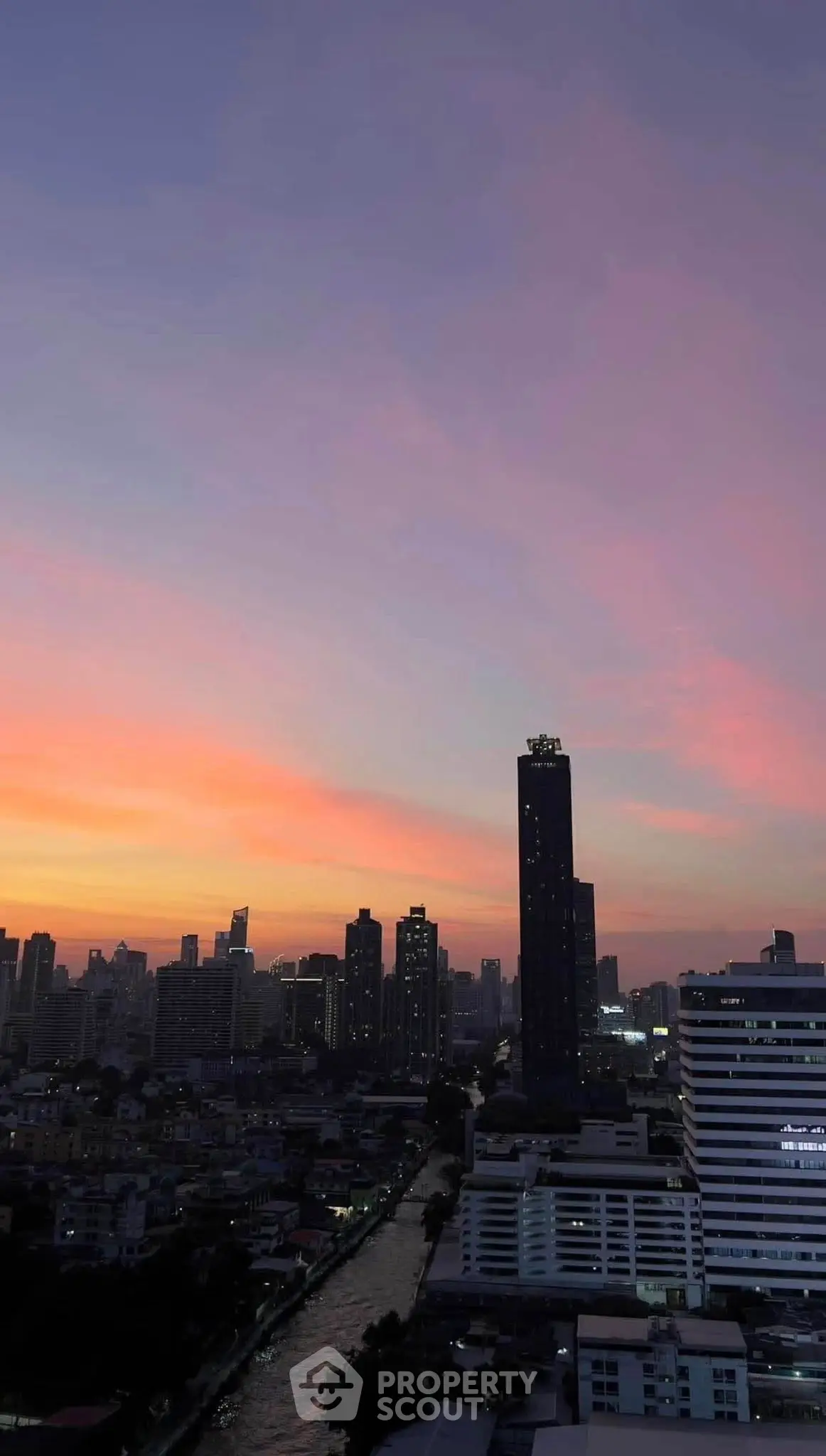 Stunning city skyline view at sunset with vibrant colors and high-rise buildings.