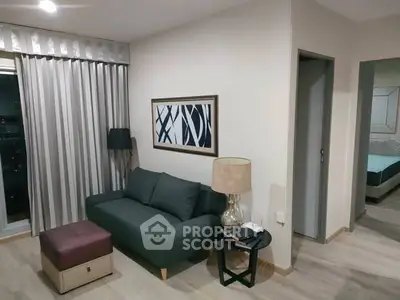 Modern living room with stylish decor and cozy seating in a contemporary apartment.