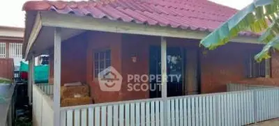 Charming rustic house with red roof and inviting porch