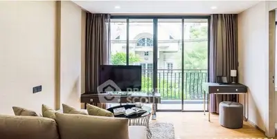 Modern living room with large windows and stylish furniture, offering a cozy and inviting atmosphere.