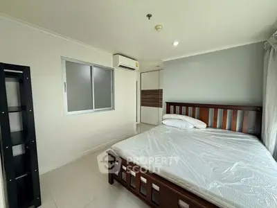 Spacious bedroom with modern furnishings and natural light