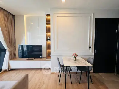 Modern living room with stylish decor and dining area, featuring a sleek TV setup.