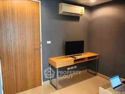 Modern study room with sleek desk and wall-mounted air conditioner