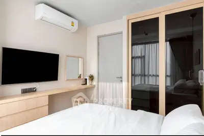 Modern bedroom with sleek design, featuring a wall-mounted TV and air conditioning for ultimate comfort.