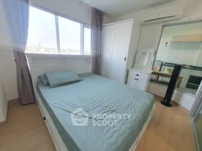 Cozy bedroom with large window and air conditioning, featuring a comfortable bed and modern decor.