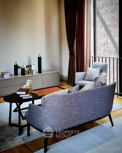 Elegant living room with modern furniture and large window, perfect for relaxation and entertaining.