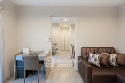 Modern living room with cozy sofa and stylish study area in open layout apartment.