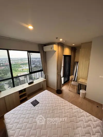 Modern bedroom with large windows offering stunning city views and natural light.