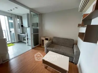 Modern living room with open kitchen layout and stylish furniture in a cozy apartment.