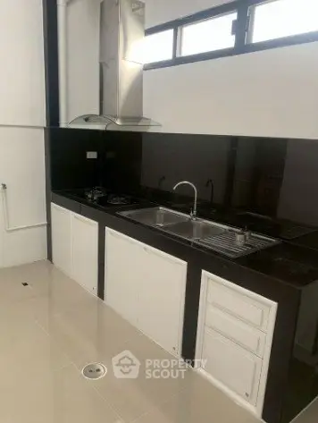 Modern kitchen with sleek black countertops and built-in gas stove