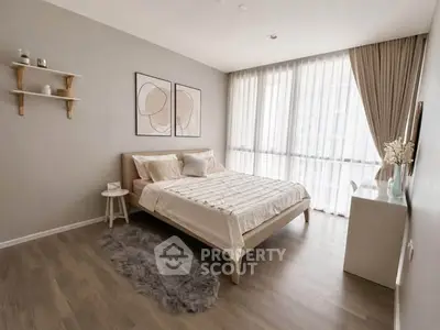 Modern bedroom with large windows and stylish decor in a cozy apartment.