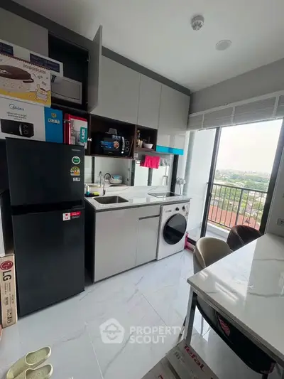 Modern kitchen with sleek cabinetry, integrated appliances, and a scenic view from the window.