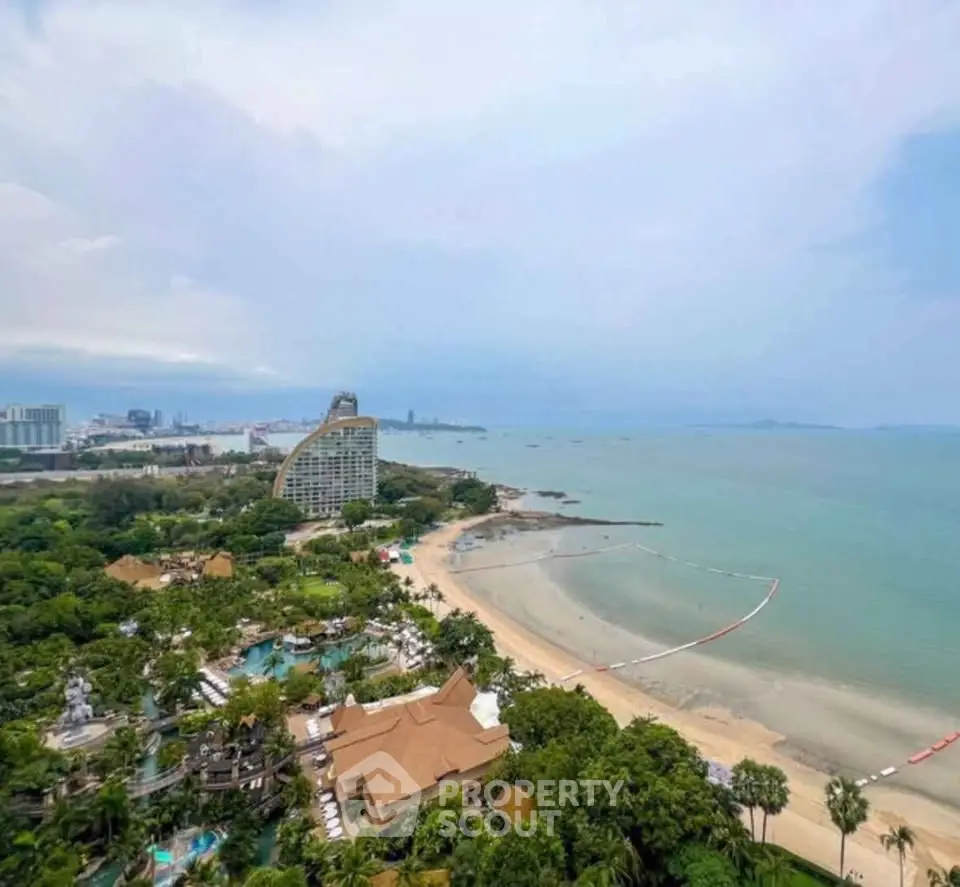 Stunning beachfront view with lush greenery and modern architecture, perfect for luxury living.