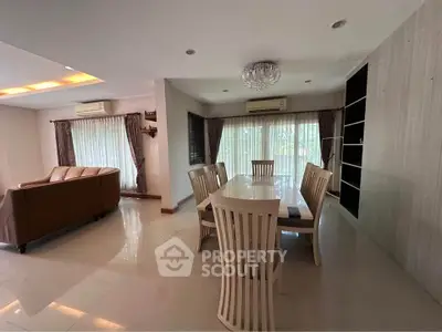Spacious living and dining area with elegant furniture and natural light.