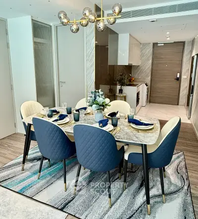 Luxurious dining area with elegant decor and modern kitchen in open layout apartment.
