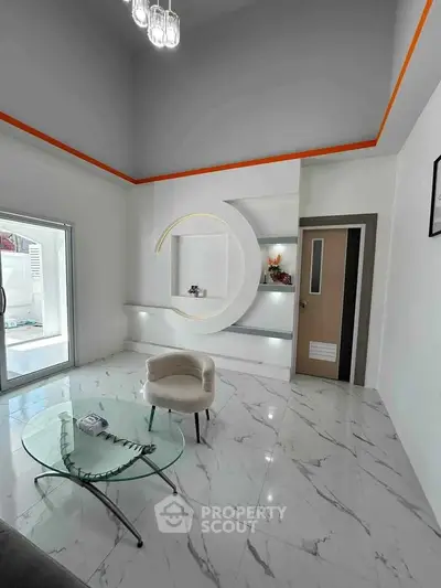 Modern living room with marble flooring, circular wall design, and glass coffee table.
