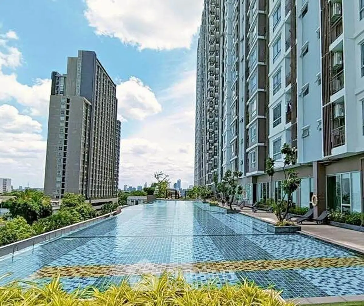 Luxurious high-rise apartment with stunning rooftop pool and city views.