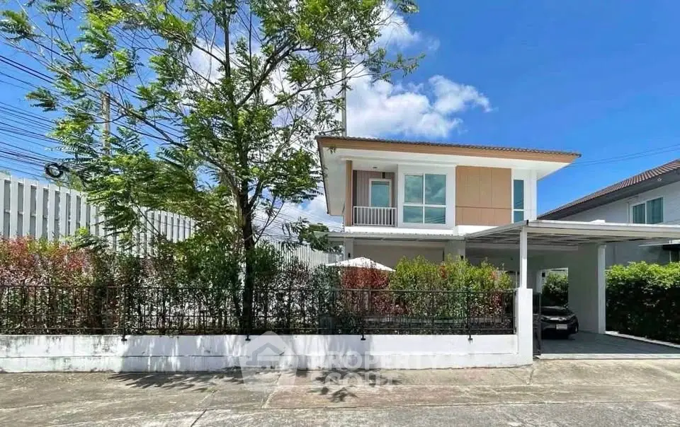 Charming two-story house with carport and lush garden in a serene neighborhood.