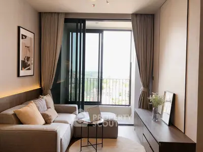 Modern living room with balcony view, cozy sofa, and stylish decor.