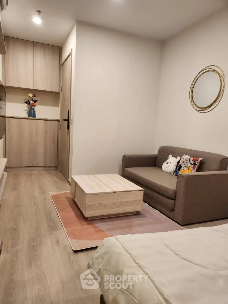 Cozy living room with modern decor and compact furniture