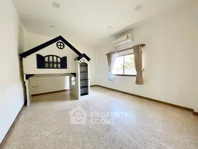 Spacious bedroom with unique playhouse feature and natural light.