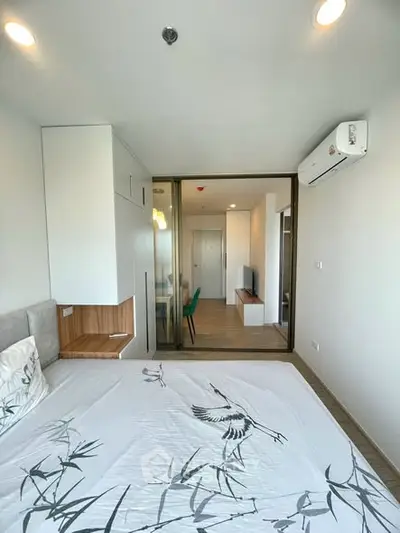 Modern bedroom with stylish decor and air conditioning in a contemporary apartment.