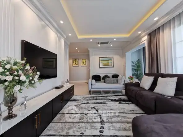 Luxurious living room with modern decor, plush seating, and ambient lighting for a cozy atmosphere.