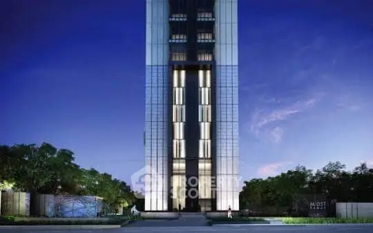 Stunning modern high-rise building with sleek architecture and illuminated facade at dusk.