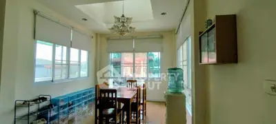 Bright dining area with large windows and elegant chandelier