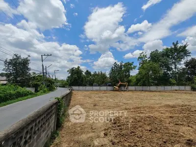 Spacious vacant land plot with clear blue sky, ideal for development opportunities.