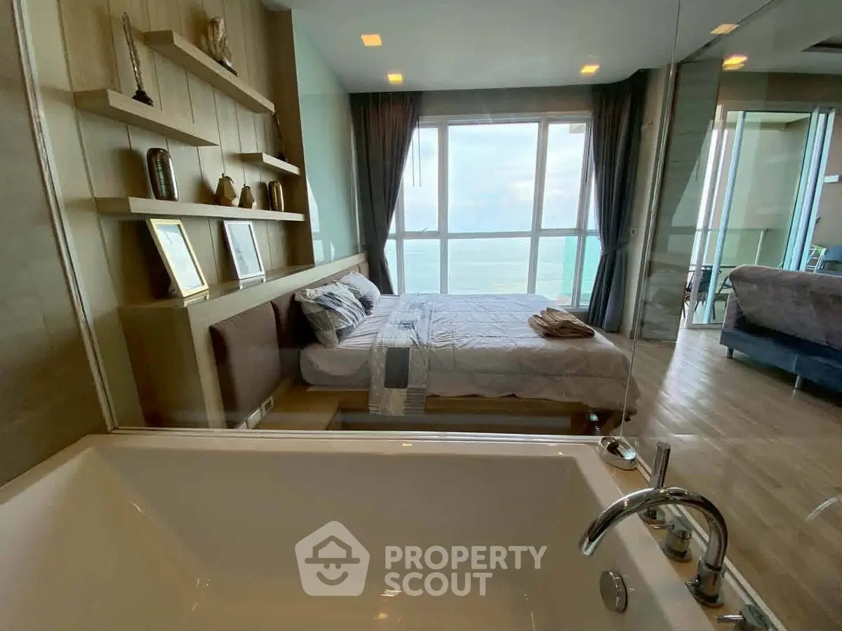 Luxurious bedroom with ocean view and modern bathtub in high-rise apartment