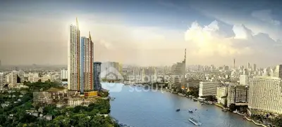 Stunning cityscape view with modern skyscrapers along a river, showcasing prime real estate location.