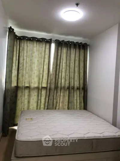 Cozy bedroom with natural light and elegant curtains