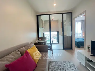 Modern apartment interior with cozy living room and open kitchen layout, featuring bright decor and natural light.