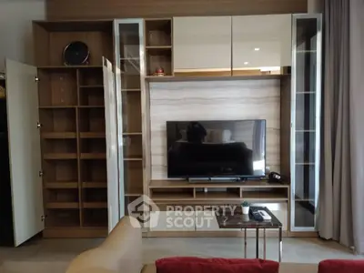 Modern living room with stylish TV unit and open shelving, perfect for contemporary urban living.