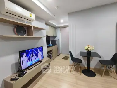 Modern living room with open kitchen, stylish decor, and cozy dining area in a contemporary apartment.